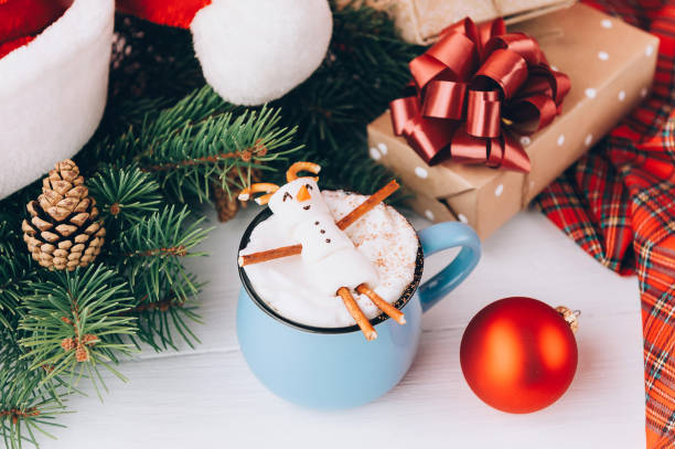 istock a mug with hot chocolate on a wooden table with a marshmallow man who is resting in a mug 863114418