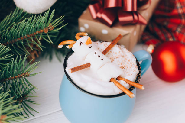 istock a mug with hot chocolate on a wooden table with a marshmallow man who is resting in a mug 863114454