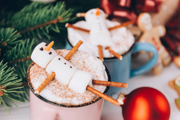 istock a mug with hot chocolate on a wooden table with a marshmallow man who is resting in a mug 863114500