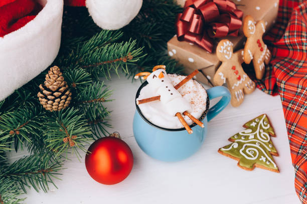 istock a mug with hot chocolate on a wooden table with a marshmallow man who is resting in a mug 863114508