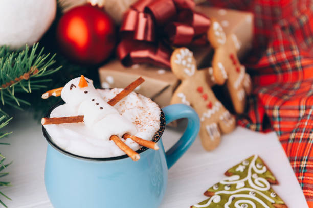 istock a mug with hot chocolate on a wooden table with a marshmallow man who is resting in a mug 863114510