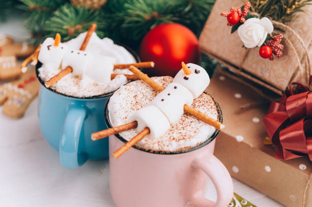 istock a mug with hot chocolate on a wooden table with a marshmallow man who is resting in a mug 863114572
