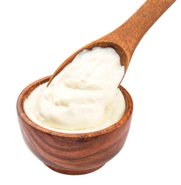 istock Sour cream in wooden spoon isolated on white background 863114588