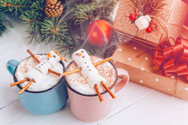 istock a mug with hot chocolate on a wooden table with a marshmallow man who is resting in a mug 863114652