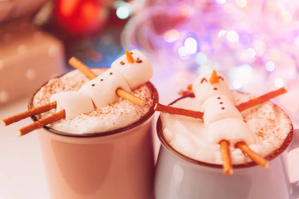 istock a mug with hot chocolate on a wooden table with a marshmallow man who is resting in a mug 863114656