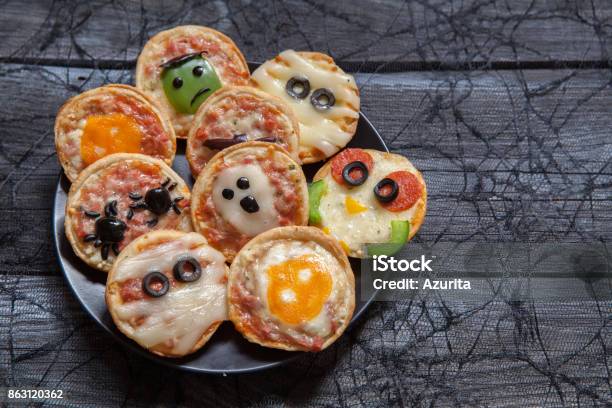 Mini Pizzas Decorated For A Halloween Stock Photo - Download Image Now - Autumn, Backgrounds, Black Color