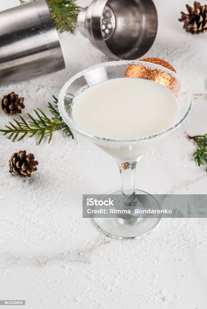 Christmas Snowflake Martini Ideas and recipes for Christmas drink. White Chocolate Snowflake Martini cocktail, on white marble table with Christmas decoration, copy space Martini Stock Photo