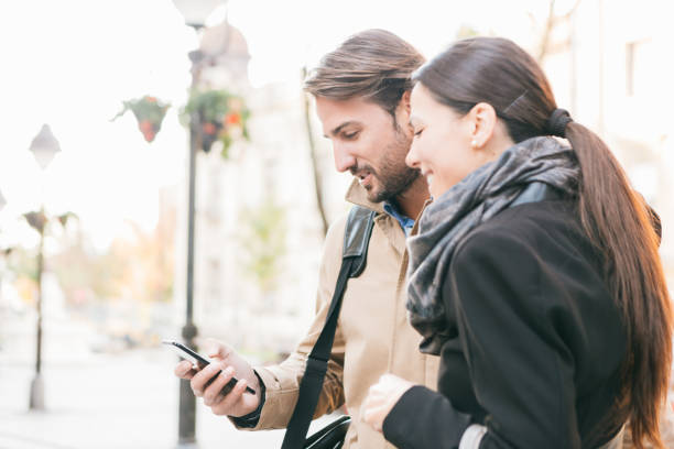 istock Commuting. Business people, colleagues, commuting to work, talking, smiling, using mobile phone 863125016