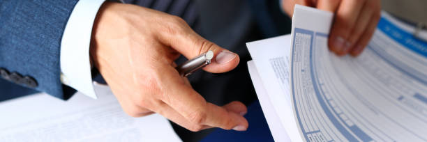 male arm in suit offer insurance form clipped to pad - transportation form imagens e fotografias de stock