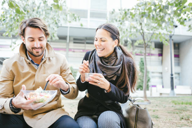 istock Commuting. Business people having lunch break outdoors, at park 863132702