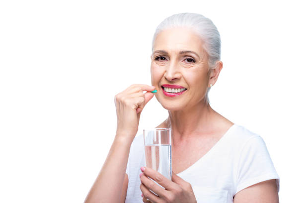 istock senior woman with pill 863133042