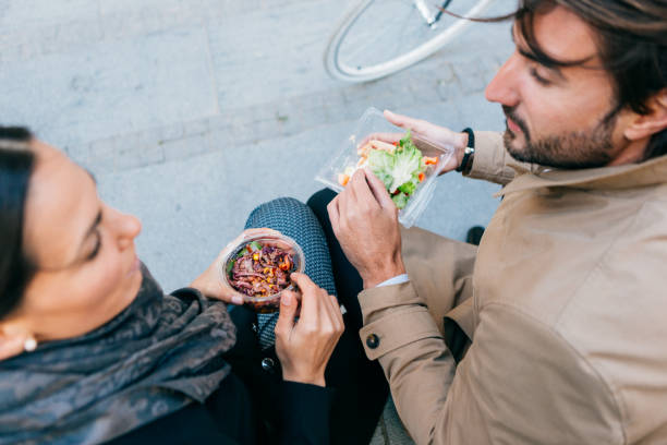 istock Commuting. Business people having lunch break outdoors, at park 863135790