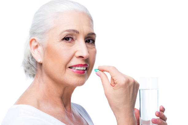 istock senior woman with pill 863139170