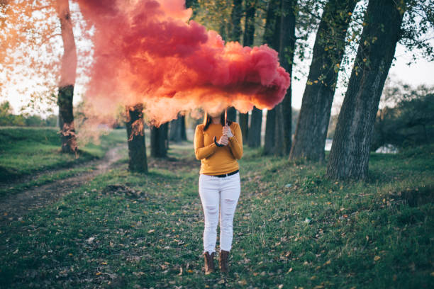 istock Woman holding smoking umbrella at park 863141408