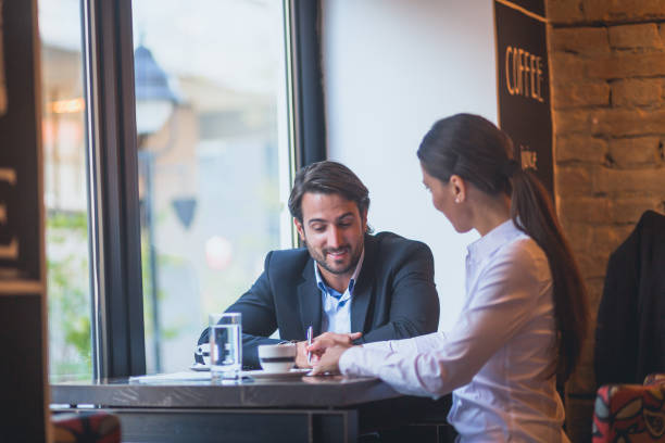 istock Commuting. Business people relaxing after work, having conversation in cafe 863141922