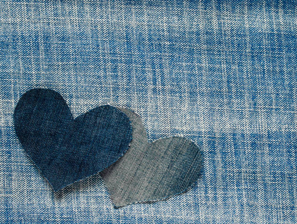 istock two hearts cut from blue denim in a stylish background 863142302
