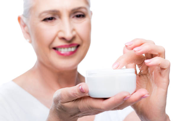 istock senior woman with face cream 863147934