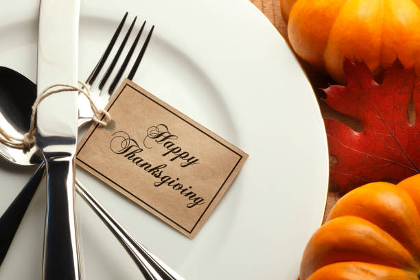 istock Happy Thanksgiving Tag Tied To Silverware On A Table Setting 863148228