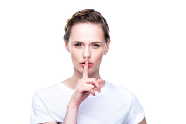 istock woman with silence symbol 863148378