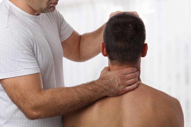 istock Chiropractic back adjustment. Muscular Man suffering from back and neck pain. 863148544