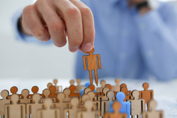 istock Man hand puts his blue silhouette on certain position organization 863155010