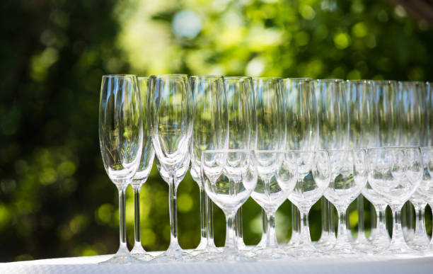empty glasses arranged on a table in the restaurant, cafe, or bar. preparation for the birthday, wedding, or any celebration day. - bentham imagens e fotografias de stock