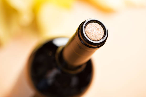 a closed bottle of red wine. top view. - cork tops imagens e fotografias de stock