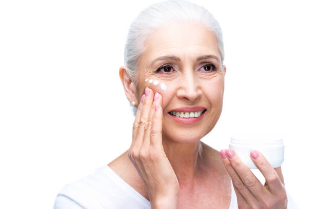 istock senior woman applying cream 863158650