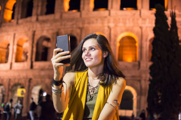 istock Smiling young woman using phone in Rome, Italy 863162342