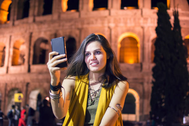 istock Smiling young woman using phone in Rome, Italy 863162348
