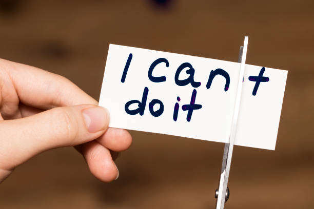 istock Man using scissors to remove the word can't to read I can do it concept for self belief, positive attitude and motivation 863170562