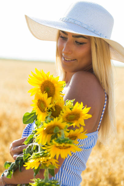 istock Woman and sunflowers 863170662