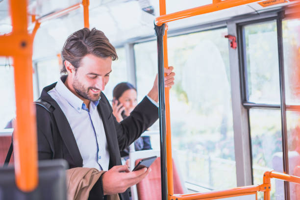 istock Commuting. Businessman using mobile phone, traveling in public transportation. 863170674