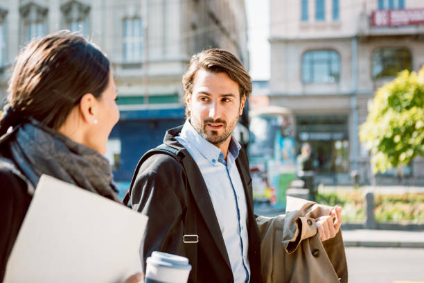 istock Commuting. Two business people, walking outside, having discussion while walking 863170732