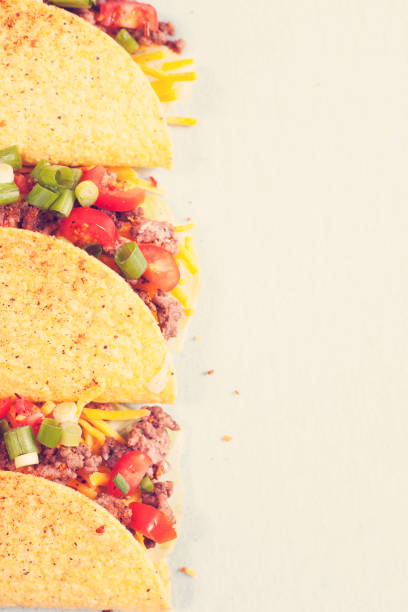 istock Mexican food crunchy beef tacos in a row. 863174040