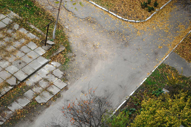 istock Old yard road covered by fallen autumn leaves. 863176956