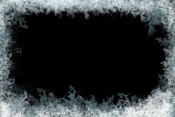 Decorative ice crystals frame on black matte background Decorative ice crystals on a window in form of a frame on black matte background frost on glass stock pictures, royalty-free photos & images