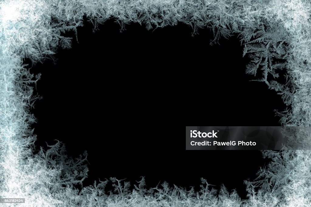 Decorative ice crystals frame on black matte background Decorative ice crystals on a window in form of a frame on black matte background Frost Stock Photo