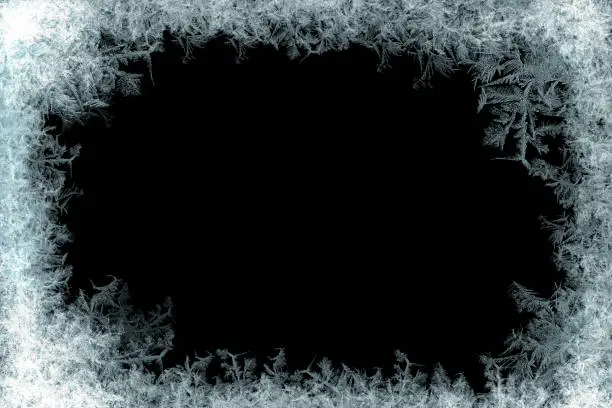 Photo of Decorative ice crystals frame on black matte background