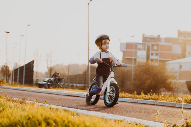 istock Little cute boy riding bicycle with a safe helmet 863187912