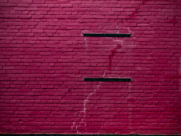 istock Old grungy brick wall painted pink. 863190510