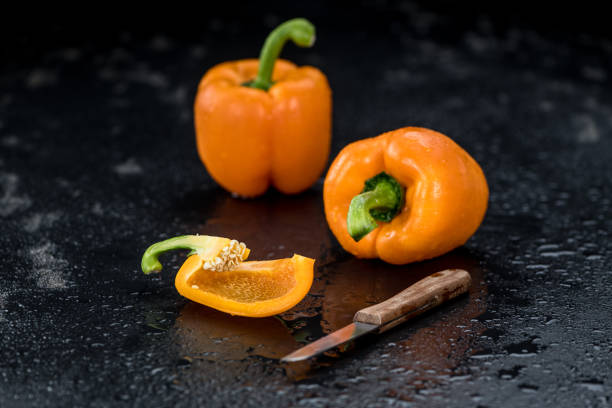 Some healthy Orange paprika on a vintage slate slab (selective focus)
