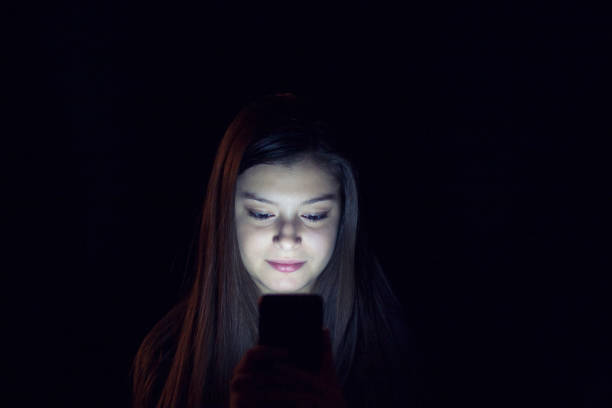 istock Teenager using smartphone at night 863190632