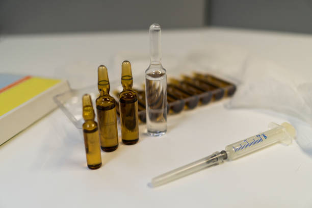 istock Syringe and ampoules with medicine lie on a white background 863190936