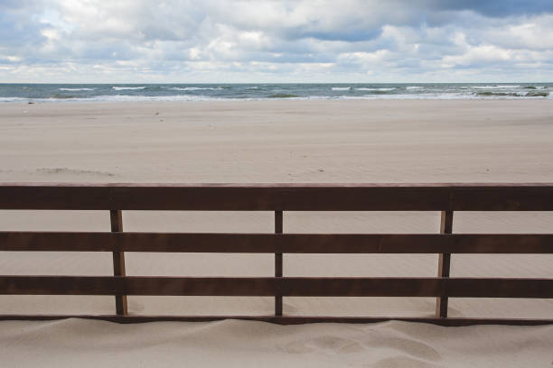 istock wooden fence in the sand on the beach 863198744
