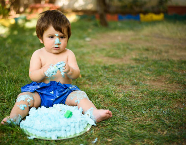 istock Baby playing with a cake during cake smash birthday party 863204212