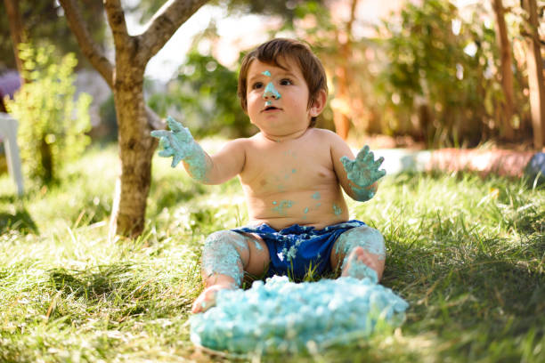 istock Baby playing with a cake during cake smash birthday party 863204310