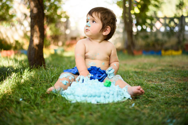 istock Baby playing with a cake during cake smash birthday party 863204352