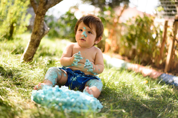 istock Baby playing with a cake during cake smash birthday party 863204360