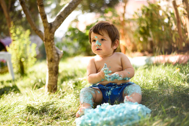 istock Baby playing with a cake during cake smash birthday party 863208466